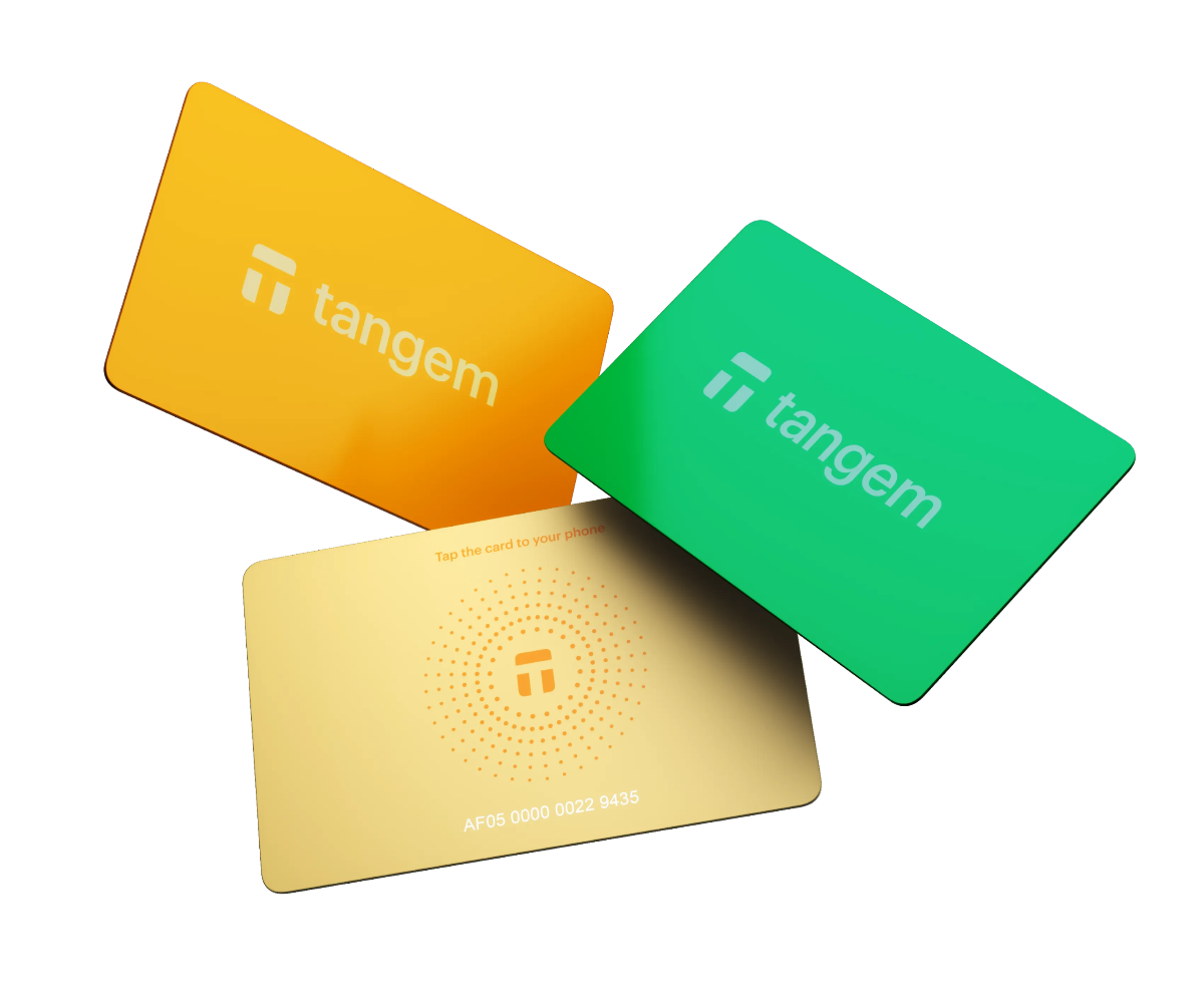 Three Tangem cards in yellow, green, and beige on a white background